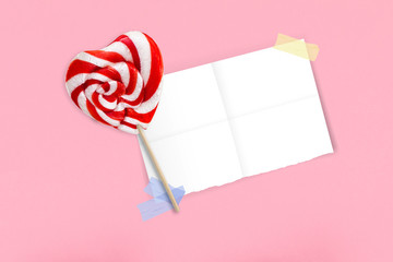 Christmas decor with candy cane on a pink background. Holiday festive theme on a pink pastel background.