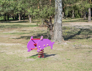 colorful playground in the park - spring rider