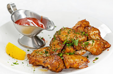 A plate with meat dishes, kebabs, bishtex, sauces and various croutons.