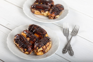 Ekler Pasta / Chocolate Donut in plate on white background.
