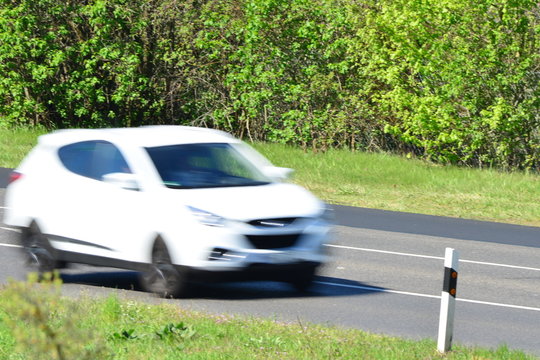 Blurred Car Passing By On A Sunny Day In Europe