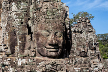 Fototapeta na wymiar The faces are only seen in the Angkor Thom. This big temple is part of the Angkor Wat complex near Siem Reap in Cambodia.