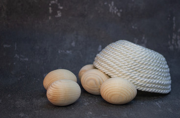 Decorative wooden Easter eggs in a wicker plate basket