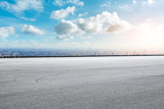 Shanghai city skyline and asphalt race track ground at sunrise,high angle view