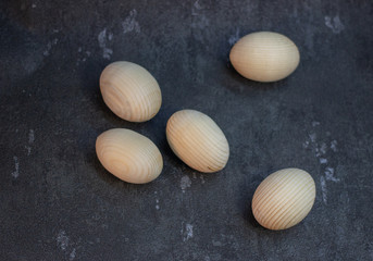Decorative wooden Easter eggs in a wicker plate basket