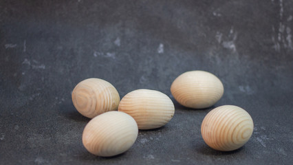 Decorative wooden Easter eggs in a wicker plate basket