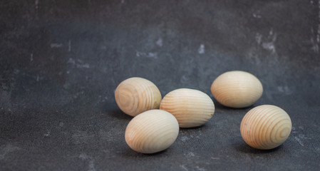 Decorative wooden Easter eggs in a wicker plate basket