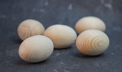 Decorative wooden Easter eggs in a wicker plate basket
