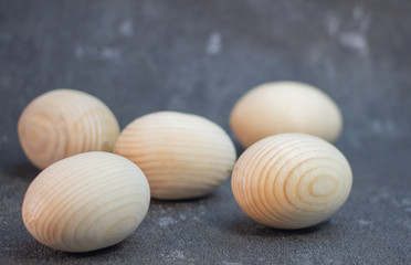 Decorative wooden Easter eggs in a wicker plate basket