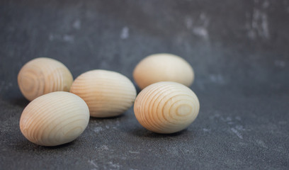 Decorative wooden Easter eggs in a wicker plate basket