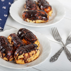 Ekler Pasta / Chocolate Donut in plate on white background.