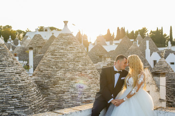 Happy beautiful wedding couple posing outdoor in roamntic city