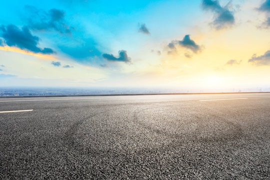 Shanghai city skyline and asphalt race track ground at sunrise,high angle view