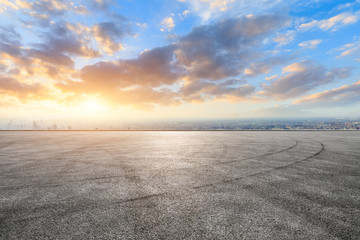 Shanghai city skyline and asphalt race track ground at sunrise,high angle view