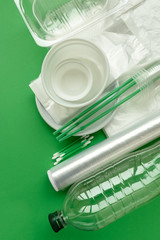 Plastic packages on green background. Copy space. Top view. Eco and save earth concept.