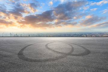 Fototapeta premium Shanghai city skyline and asphalt race track ground at sunrise,high angle view