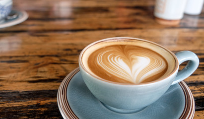cup of latte coffee on wooden table