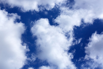 Big white fluffy clouds in the blue sky.Summer background.