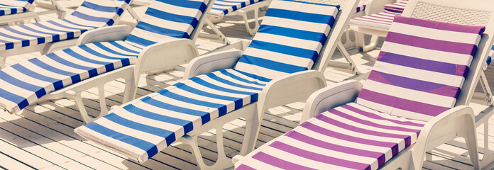 Blue deck chairs at the swimming pool
