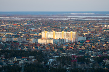 Yakutsk city downtown aerial view from hill at amazing sunset. Sunrise or sunset overlooking the new buildings of the city