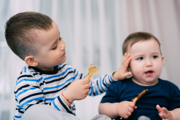 Brother and sister eat lollipops in the form of a cock