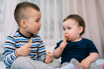 Brother and sister eat lollipops in the form of a cock