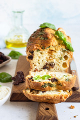 Savoury loaf cake with dried tomatoes, mozzarella and basil. Selective focus.