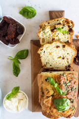 Savoury loaf cake with dried tomatoes, mozzarella and basil. Selective focus.