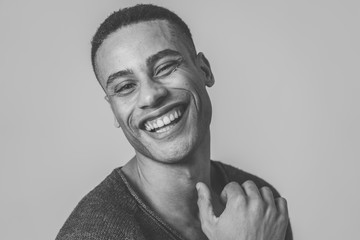 Close up portrait of smiling and laughing attractive man in happy face human emotion and expression