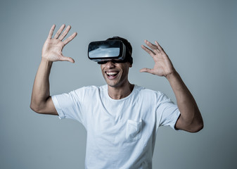Portrait of cheerful and shocked young man wearing Virtual Reality headset exploring 3D world