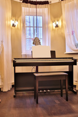 Old piano in the ancient house. The room is aged style. Interior of the home.