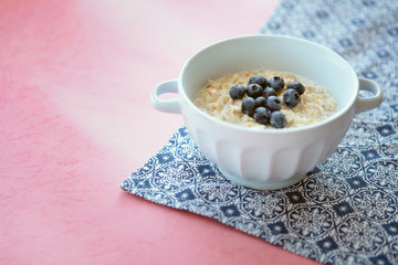 Fototapeta na wymiar Oatmeal porridge with blueberry, blackberries and currants for breakfast