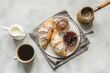 Cup of coffee, freshly baked croissants. Top view. Flat lay. Concept french breakfast.
