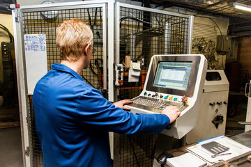 A technician using a computer in industry