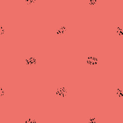 Black varied grunge stipple on bright coral background. Bold seamless geometric vector pattern with modern urban vibe. Timeless print for stationery, packaging, fabric, fashion, giftwrap