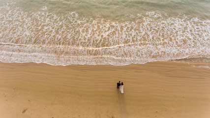 Happy wedding couple posing on beach