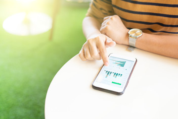 Woman using smart phone for check data at cafe