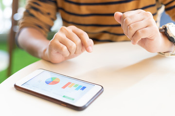Woman using smart phone for check data at cafe