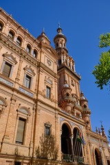 Fototapeta na wymiar building of Andalisia Seville's main square Plaza de Espana Spain. blue decorative ceramic element.