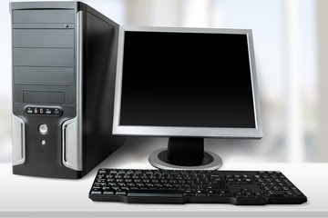 Desktop computer and keyboard on background