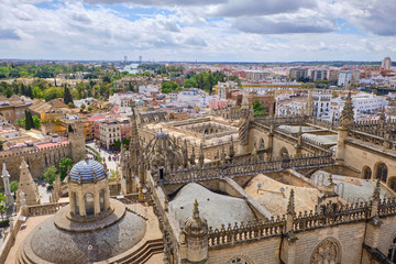 Fototapeta na wymiar Aerial view of the Cathedral of Saint Mary of the See (Seville Cathedral) in Seville, Andalusia, Spain in a sunny and cloudy day.