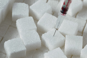 Sugar cubes with syringe - Diabetes concept