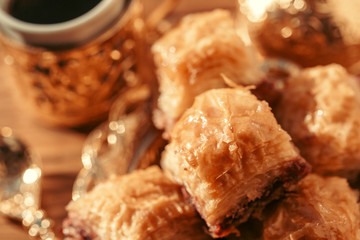 Turkish sweets with coffee on a wooden table