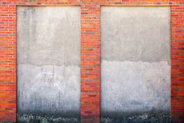 weathered stucco wall and red brick frame around.