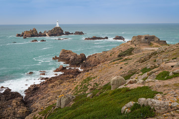La Corbiere Lighthouse and German World War 2 fortifications at high tide, Jersey, Channel Islands