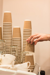 Cropped view of barista holding brown disposable cup