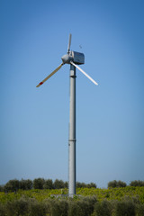 Fototapeta na wymiar Vertical View of Broken Wind Turbine on Blue Sky Background