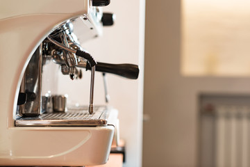 Side view of modern coffee machine with portafilter in cafe