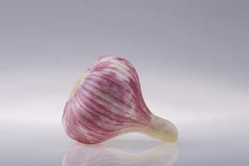 Head of young garlic on a gray background of the subject table.