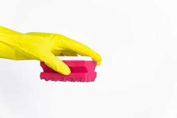 hand with yellow glove holding red sponge for cleaning on white background